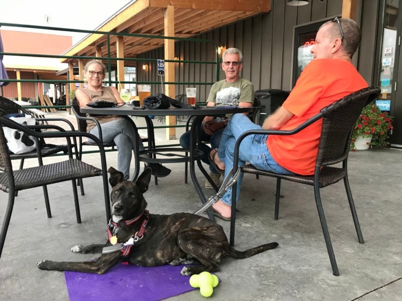 Woman and two men on Custer Beacon's pet friendly porch in Custer, SD